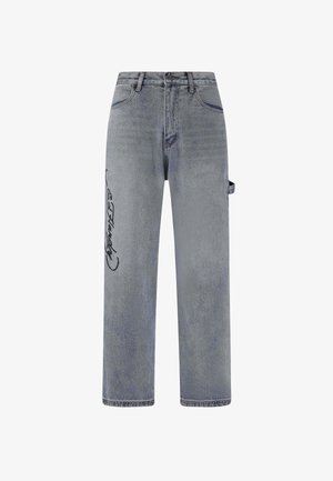 Hellgraue Jeans aus Denim mit lockerer Passform, seitlicher Tasche, auffälligem schwarzen Grafikdesign am linken Bein und sanften Verwaschungen.