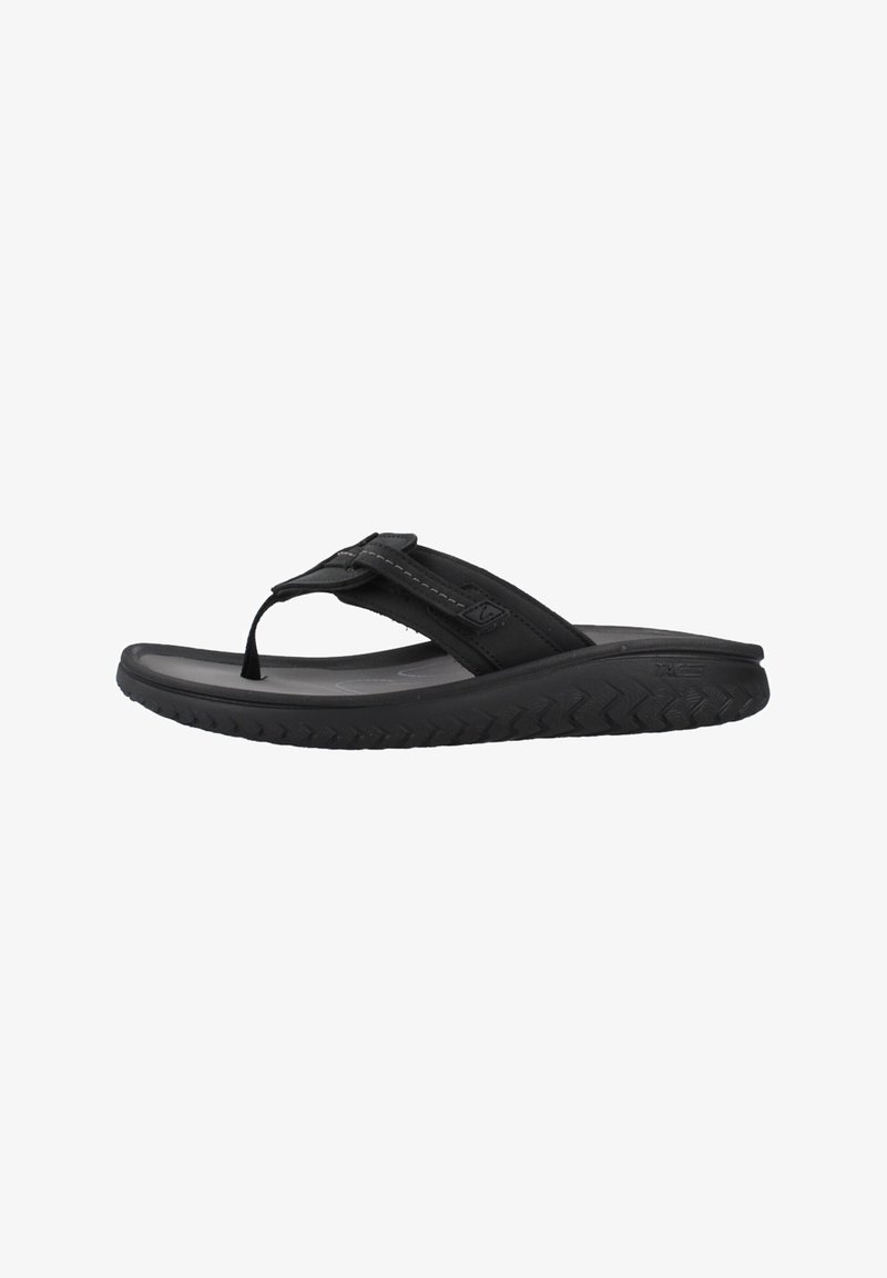 Tongs en caoutchouc noir avec semelle épaisse et rembourrée et sangle réglable sur le dessus, conçues pour un usage décontracté.