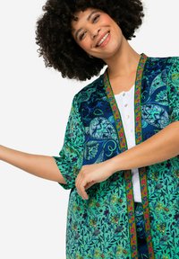 Floral-patterned kimono in blue and green hues with a colorful trim. Features short sleeves and a relaxed fit design.