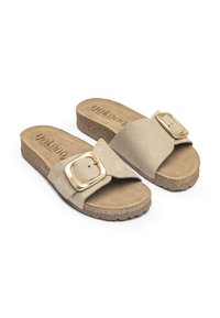 Beige slip-on sandals made of suede with a wide strap featuring a gold metal buckle. Cork footbed with a textured outsole.