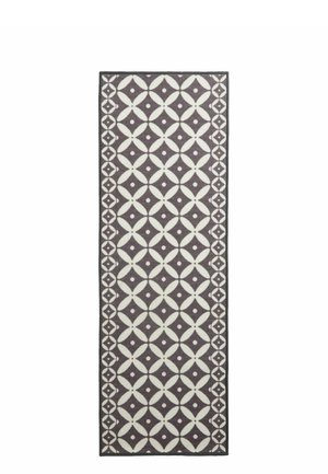 Rectangular runner rug with white geometric floral pattern on dark gray background and matching decorative border.