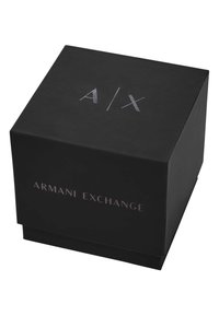 Black square box made of matte paper with embossed silver "A/X" logo on top and "ARMANI EXCHANGE" text on the front.
