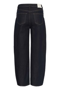 Tumši zili džinsa kuloti ar vaļēju piegriezumu, ar divām aizmugurējām kabatām un vienkāršu jostasvietu. Faktūra ir gluda ar kontrastējošu šuvju izšuvumu.