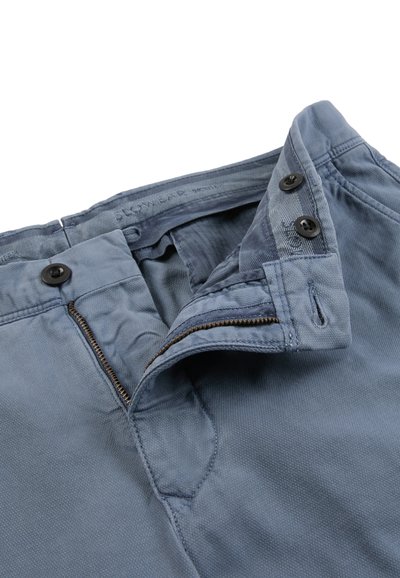 Blue trousers with a partially unzipped zipper and two black buttons on the waistband, showing inside fabric details.