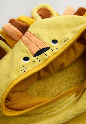 Kollase lõviteemalise kapuutsiga rätik, mis on valmistatud pehmest tekstuuriga kangast. Kapuutsil on lõvi näo ja lainesarnaste aktsentidega heledates pruunides ja oranžides toonides.