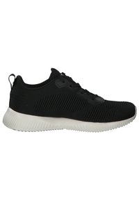 Black athletic shoe with a textured mesh upper, lace-up design, and a white rubber sole featuring a ridged pattern for traction.