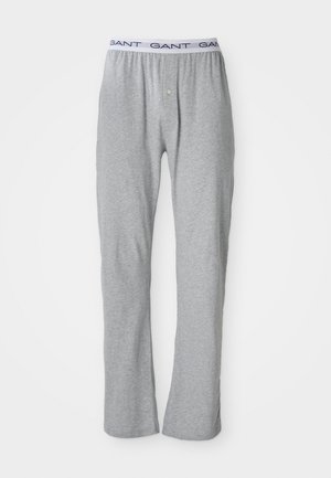 Pantalons lounge gris en coton doux avec une coupe droite, dotés d'une ceinture élastique blanche sur laquelle est inscrit "GANT" en bleu.