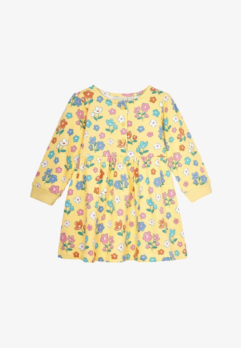 Keltainen kukallinen mekko pitkilla hihoilla, jossa on napitettu etuosa, kerrottu vyötärö ja elävä kuosi monivärisistä kukista.