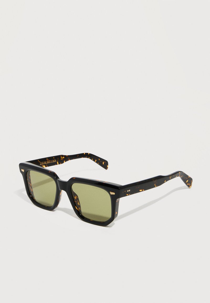 Square tortoiseshell sunglasses with thick frames and green tinted lenses, displayed against a plain white background.
