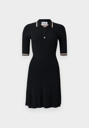 Black ribbed polo dress with a buttoned neckline, short sleeves, and contrasting beige stripes on the cuffs. Smooth texture, fitted silhouette.