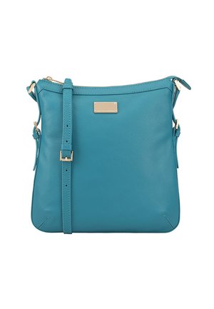 Sac en cuir turquoise porté en bandoulière avec une texture lisse, une bandoulière réglable et un subtil accent en doré à l'avant.