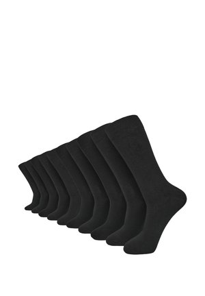 Calze di cotone nere disposte in fila, con una texture liscia e lunghezza a metà polpaccio, adatte per vari tipi di calzature.