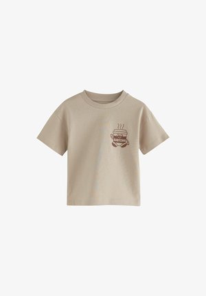 Beige kortærmet t-shirt i bomuld, med et brunt grafisk motiv af en smilende drikkekop med damp og ordet "BABYCINO."