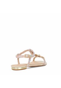 Strappy sandals in pastel pink with textured fabric. Features a gold-accented low heel, pearl embellishments, and braided straps.