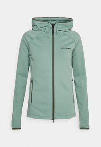 Veste à capuche en tissu doux vert clair, avec une fermeture éclair intégrale à l'avant, dotée de deux poches latérales et d'un bord contrastant foncé.