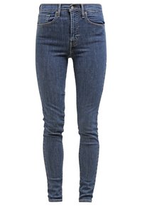 Jeans skinny in denim scuro. Presentano una vita alta, tasche frontali e una classica chiusura con zip. Texture liscia con minimale usura.