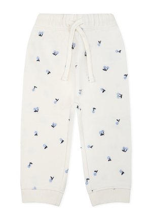 Kremowe dresowe spodnie z drawstringiem w talii, zdobione kwiatowym wzorem w jasnoniebieskim i czarnym kolorze, oraz ściągaczami przy kostkach.