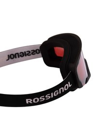 Lyžařské brýle s černým rámem, červeně zabarveným sklem a měkkou černou pěnovou výplní. Obsahují černý pásek s bílým brandingem "ROSSIGNOL".