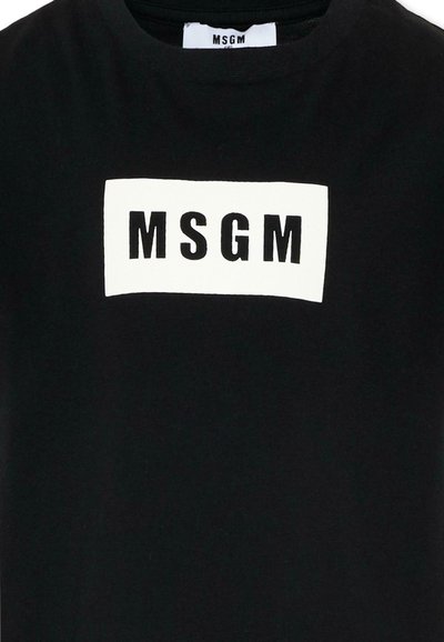Maglietta nera con una toppa rettangolare bianca sul petto, con al centro grandi lettere nere "MSGM".