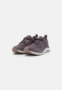 Sport shoes in dark purple with textured mesh upper, round toe, and contrasting light gray sole. Features lace closure and pull tab.