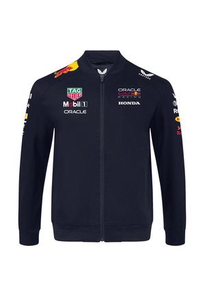 Granatowa kurtka zapinana na zamek błyskawiczny w stylu bomber, z logo na piersi i rękawach, oraz ribbowymi mankietami i dolnym wykończeniem dla lepszego dopasowania.