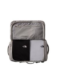 Gray travel bag interior, featuring a mesh zip pocket and two compartments with black and gray fabric, each with logo accents.