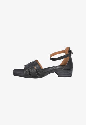 Sandalía de cuero negro con un tacón bajo, que presenta un diseño de tiras trenzadas y una correa para el tobillo con un hebilla de metal. Forro interior suave y parte superior texturizada.