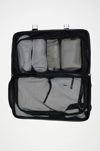 Black mesh travel bag with multiple compartments. Features gray packing cubes and zippered openings for easy access and organization.