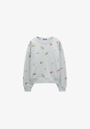 Jasnoszara bluza z długim rękawem z prążkowymi mankietami, ozdobiona rozproszonymi małymi kwiatowymi i motyli nadrukami w pastelowych kolorach.