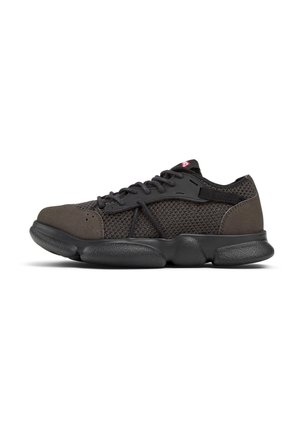 Dark gray athletic shoes featuring a mesh upper, suede accents, and textured black rubber sole. Laces and minimal branding on tongue.