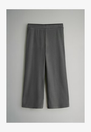 Šedé kalhoty culotte z hladké látky, s širokými nohavicemi a elastickým pasem pro pohodlí. Žádné viditelné vzory nebo detaily.