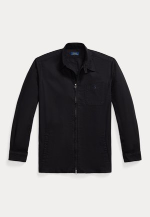 Black zip-up jacket made of smooth fabric, featuring a collared neck, long sleeves, one chest pocket, and a logo on the pocket.