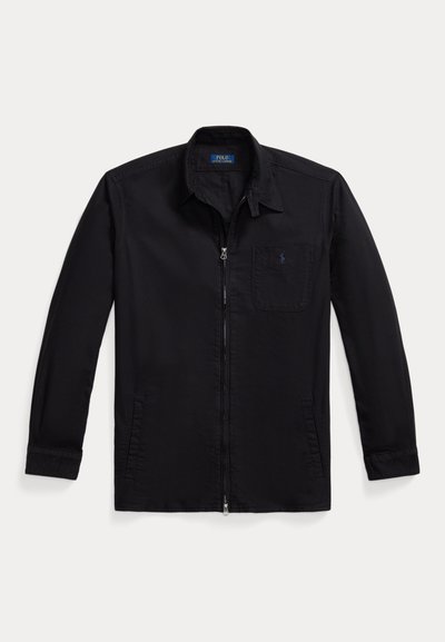 Black zip-up jacket made of smooth fabric, featuring a collared neck, long sleeves, one chest pocket, and a logo on the pocket.