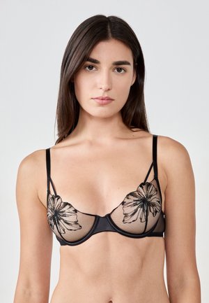 Soutien-gorge noir avec des bonnets en tulle transparent ornés de broderies florales, des bretelles réglables et une bande solide. Texture lisse avec des détails en contraste.