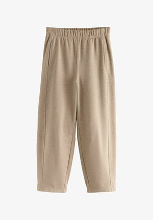 Beige Jogginghose mit elastischem Bund, Seitentaschen und lockerer Passform; aus weichem Stoff mit glatter Textur.