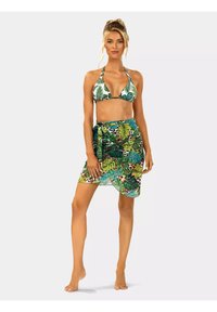 Bikini z zielonym wzorem liści i halterowymi ramiączkami, połączony z pasującą przezroczystą spódnicą w zwrotnicze liście i wzór zwierzęcy.