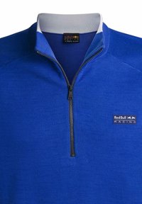 Niebieski sweatshirt typu half-zip z teksturowanym splotem, kontrastowym białym kołnierzem i czarnym suwakiem. Posiada logo Red Bull Racing na piersi.