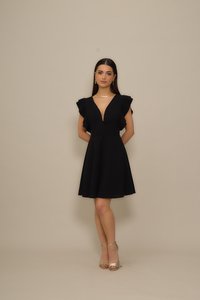 Black dress with ruffled sleeves, V-neckline, and fitted bodice; flared skirt, paired with gold ankle strap heels; smooth texture.