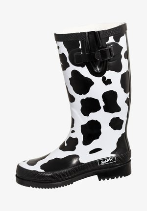 Black and white cow print rubber rain boot with black textured sole and adjustable buckle near the top, branded "SALIHA."