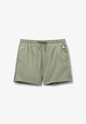 Light green swim trunks with elastic waistband, drawstring, side pockets, and a small metal bottle opener attached to the right pocket.