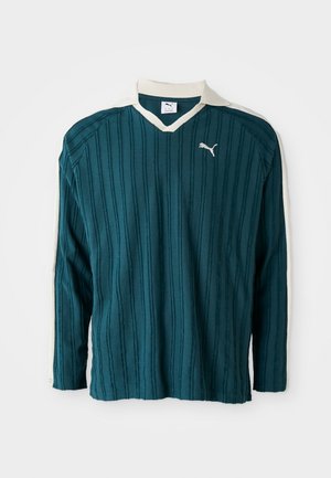 Teal long-sleeve shirt with vertical ribbed texture, V-neck, and white collar. Features a small white Puma logo on the chest.