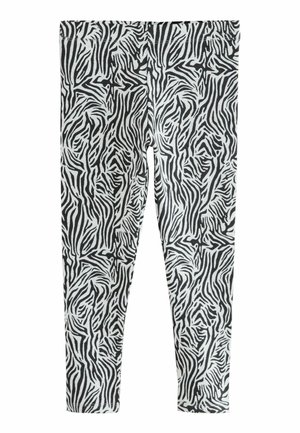 Leggings à motif zèbre noir et blanc, fabriqués en tissu doux, dotés d'une taille élastique et de jambes fuselées pour le confort et l'ajustement.