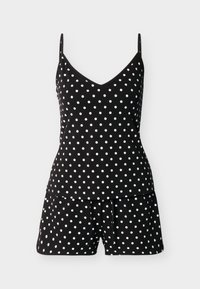 Ensemble débardeur noir et short avec des pois blancs, comprenant des bretelles fines et un décolleté en V sur le haut.