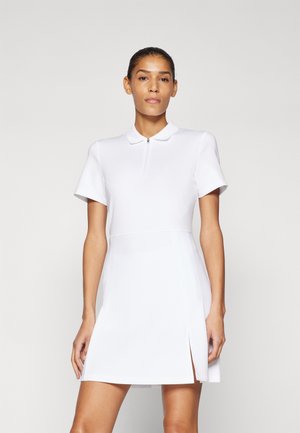 White short-sleeve polo dress with a zippered neckline. Features a fitted bodice, flared skirt, and side slits. Made from smooth, stretchy fabric.