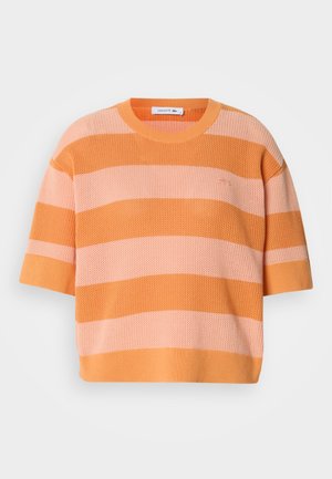 Knit striped sweater with short sleeves; features alternating orange and light pink horizontal stripes, round neckline, and loose fit.