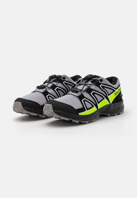 Black and gray trail running shoes with a lightweight mesh upper, yellow accents, and rubber outsole for traction. Features lace lock system.