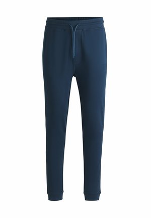 Marina sweatpants i mjukt tyg, med snörning i midjan, avsmalnande ben och subtil logotypdetalj på låret.