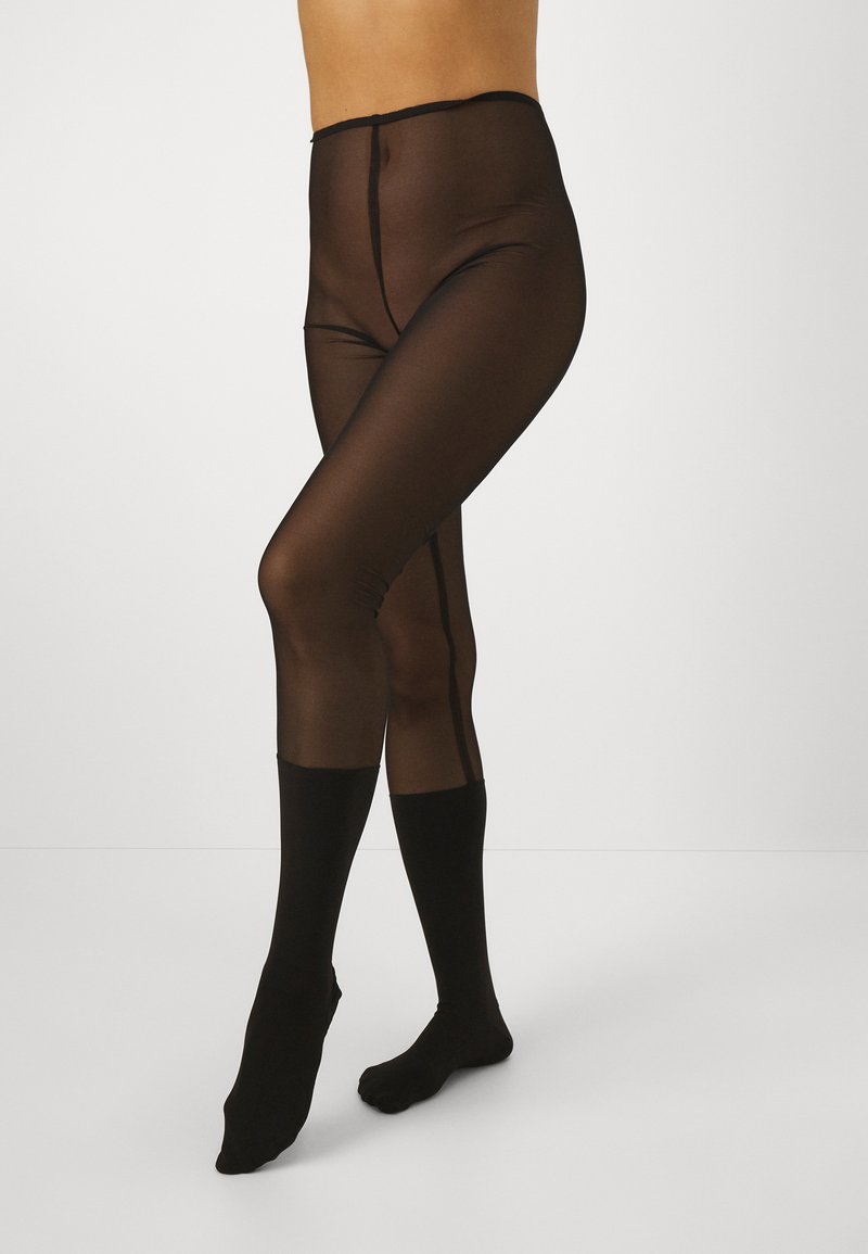 Durchsichtige schwarze Strumpfhosen mit hohem Bund und blickdichtem Fußdesign. Sie verfügen über eine glatte Textur und eine zentrale Naht entlang der Beine.