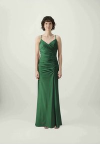 Green satin gown with a fitted bodice and ruching details, featuring thin straps and a long, flowing skirt. Smooth texture throughout.