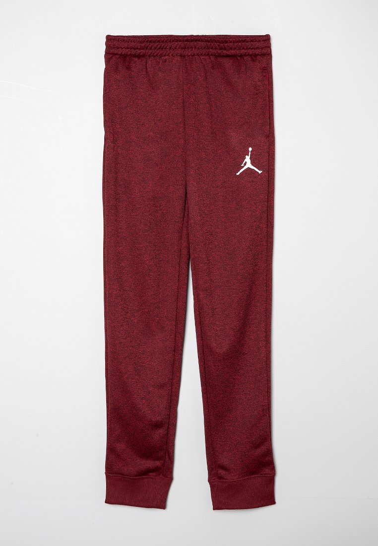 Burgunderfarbene Sporthosen aus strukturiertem Material mit einem elastischen Bund und elastischen Bündchen. Mit einem weißen Jumpman-Logo am linken Bein.